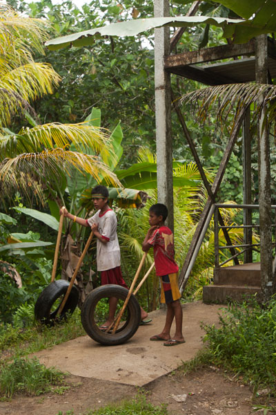 Boys roll tires for a game, Pohnpei, Federated States of Micronesia (FSM)