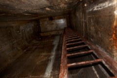 A ladder leading up to the entrance into a massive subterranean oil tank on Lenger